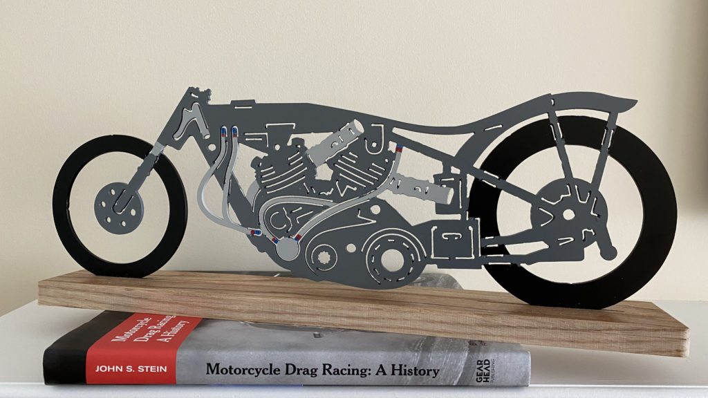 Clem Johnson's Vincent drag bike is shown here sitting on a book about motorcycle racing.